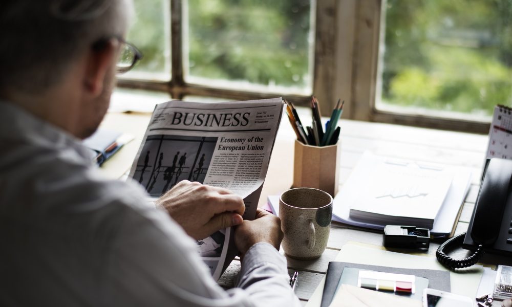 businesspeople-reading-newspaper-at-office-updating-news.jpg